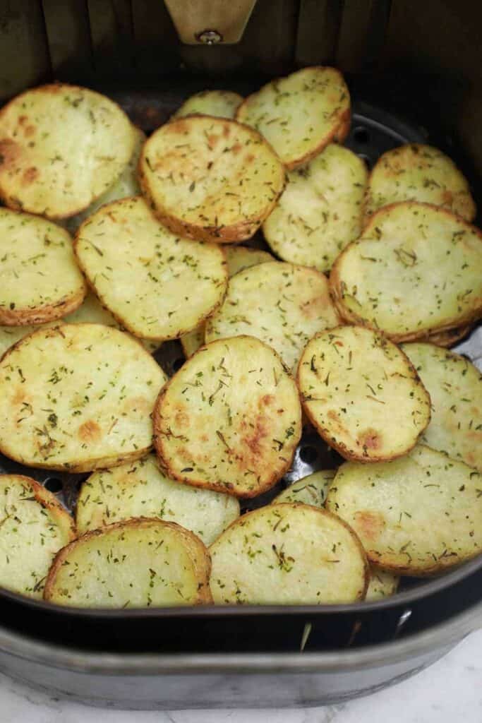 cooked potato slices in air fryer.