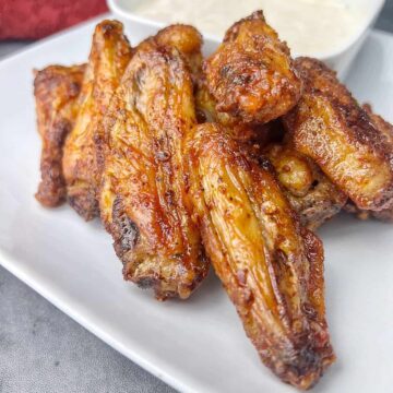 cooked air fried frozen wings served on a plate.