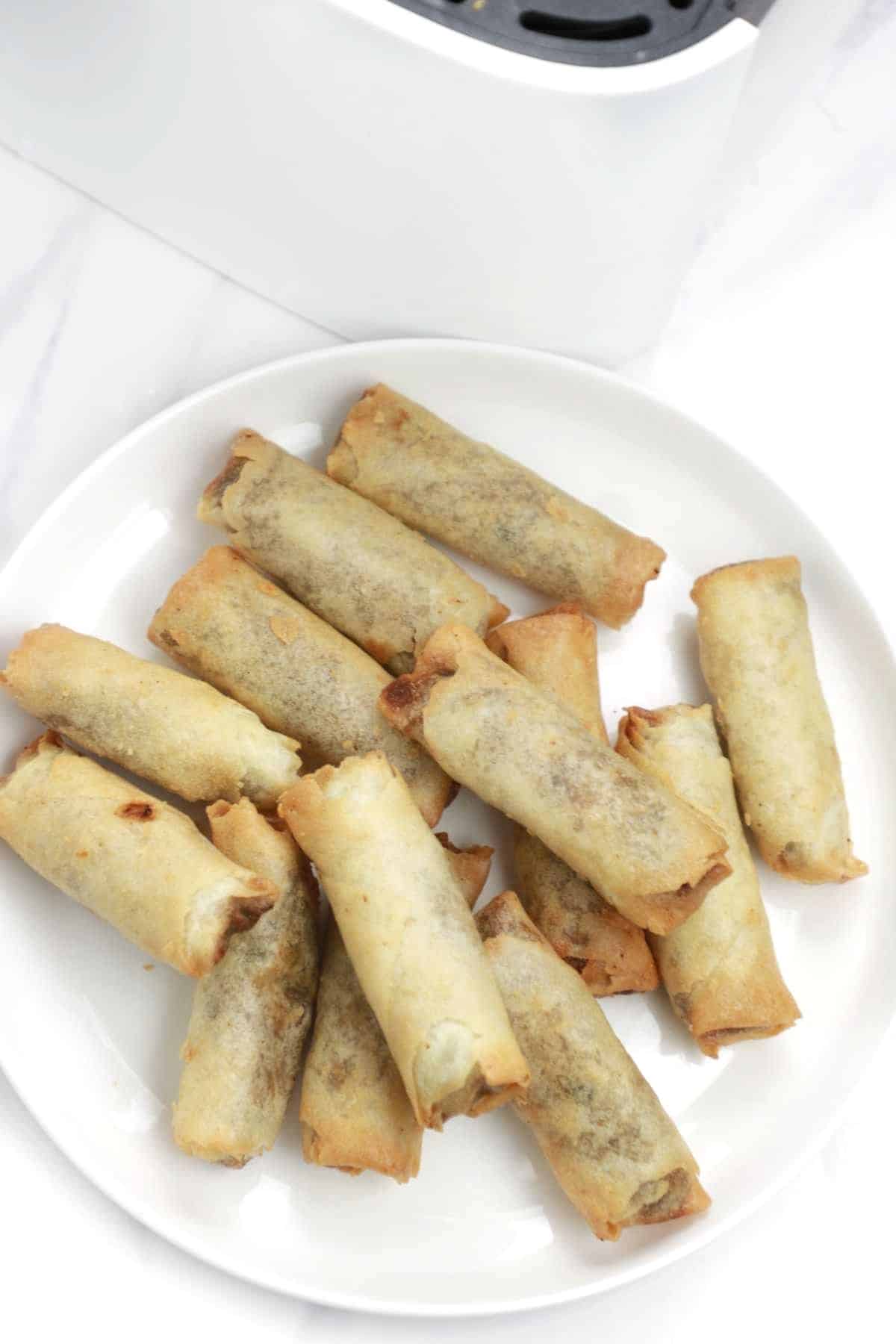 spring rolls served on a white plate.