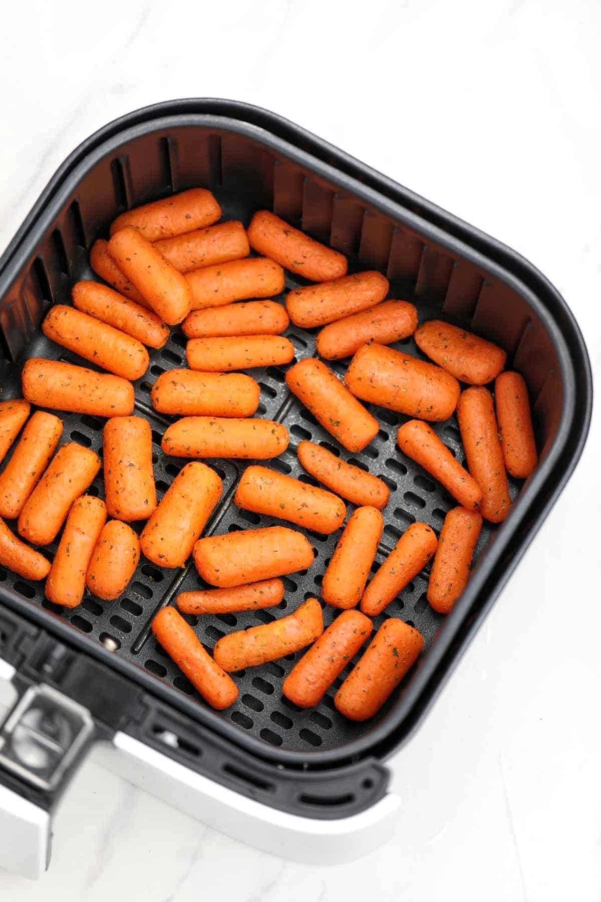 baby carrots in air fryer basket.